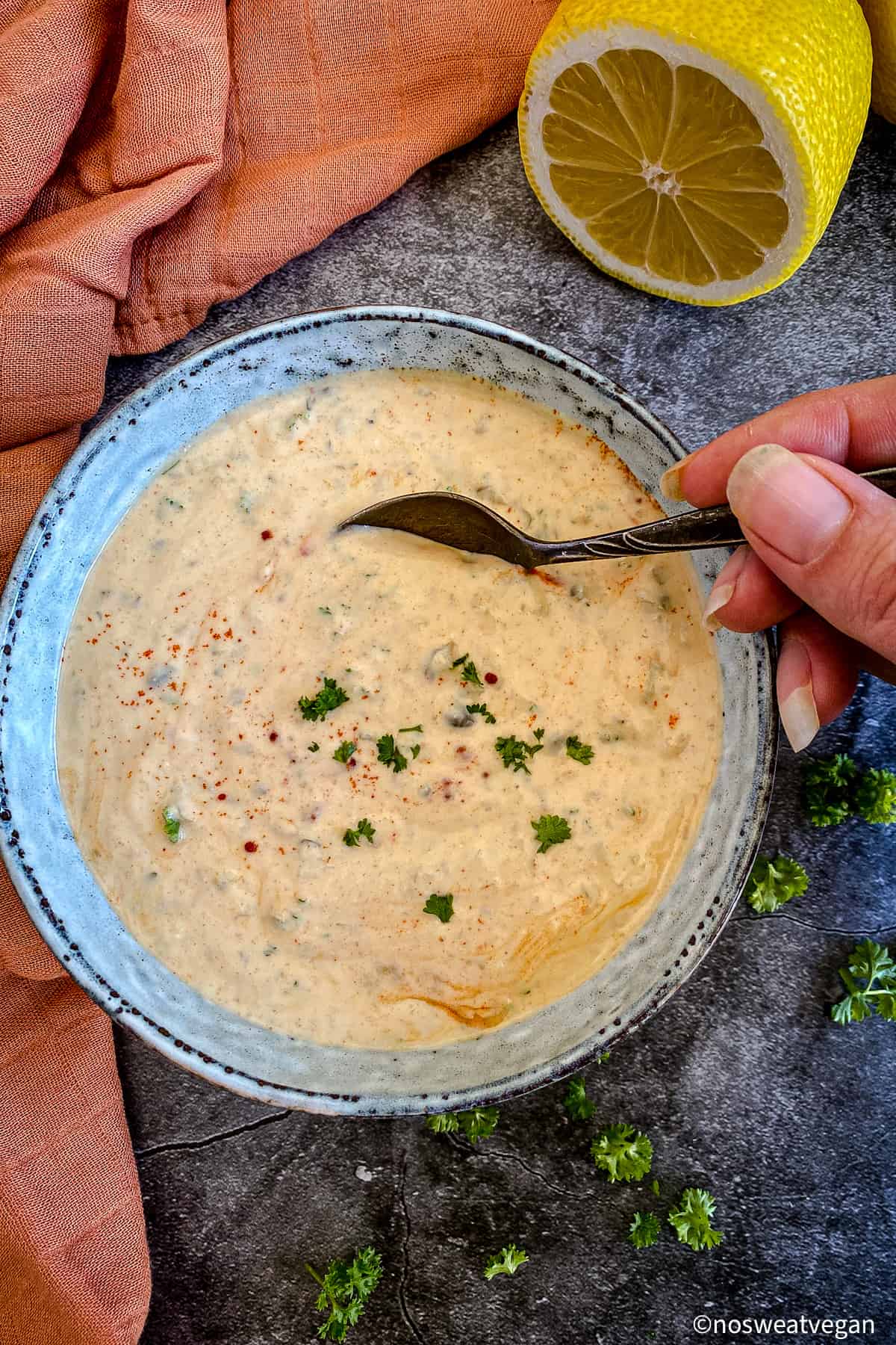 Spoon dipping into vegan remoulade.