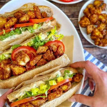 Three vegan Po Boys on a plate.