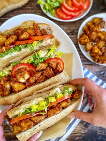 Three vegan Po Boys on a plate.