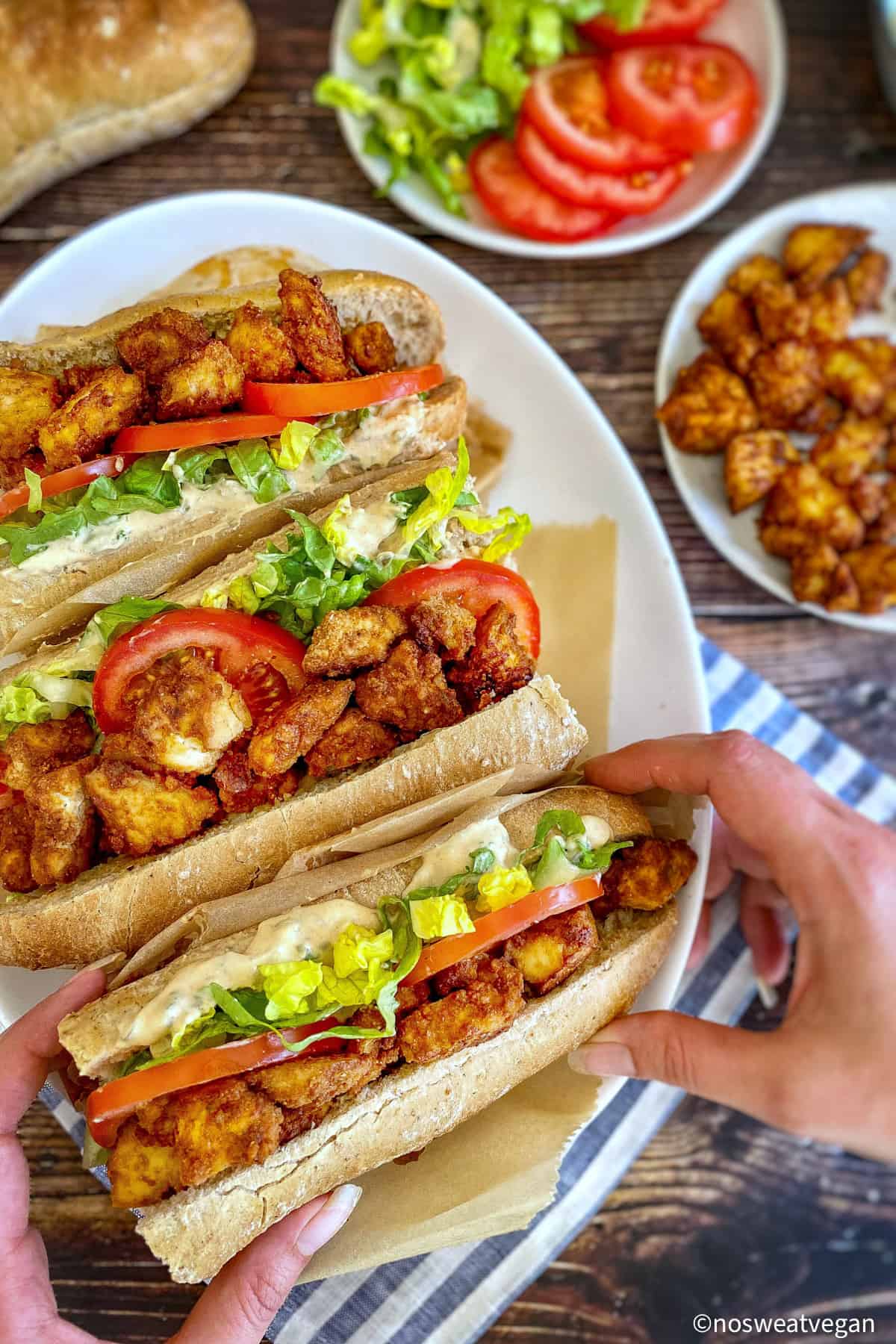 Three vegan Po Boys on a plate.