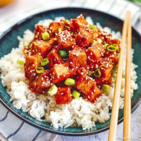 Vegan Korean tofu in bowl with rice and chopsticks.