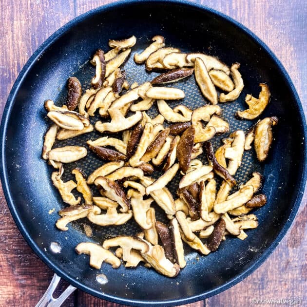 Cooked Shiitake mushrooms in skillet.