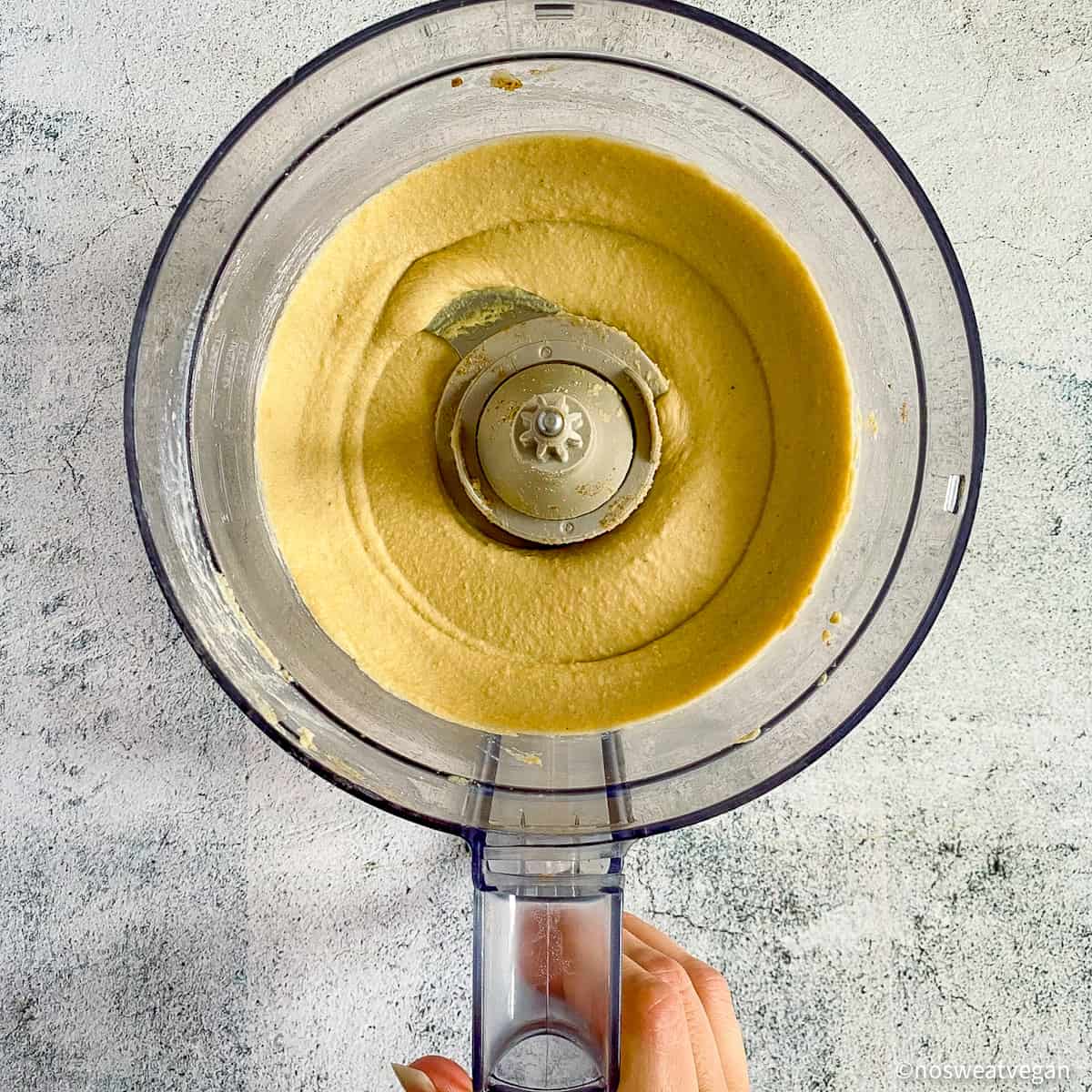Creamy oil-free hummus in food processor.