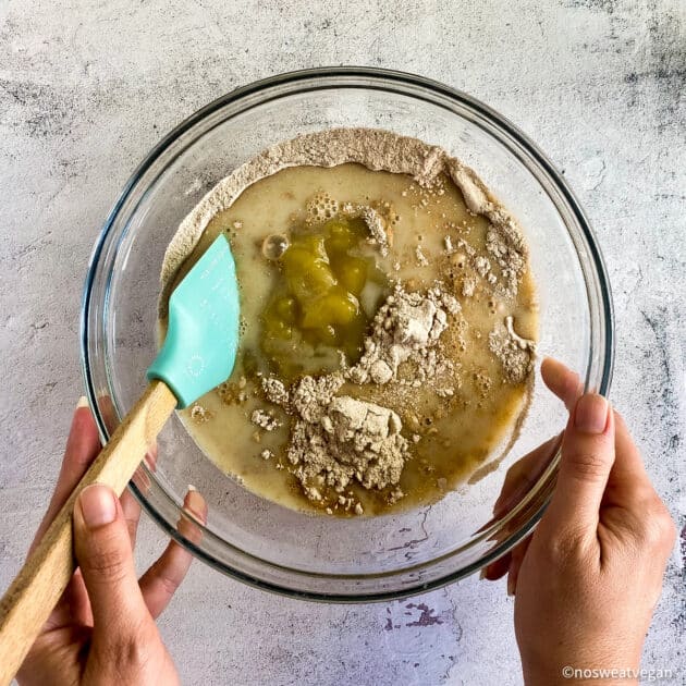Vegan whole wheat muffins wet and dry ingredients in bowl.