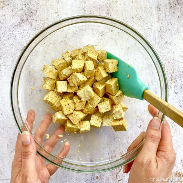 Cubed tofu in bowl with soy sauce.