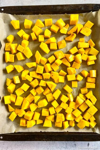 Cubed butternut squash on sheetpan.