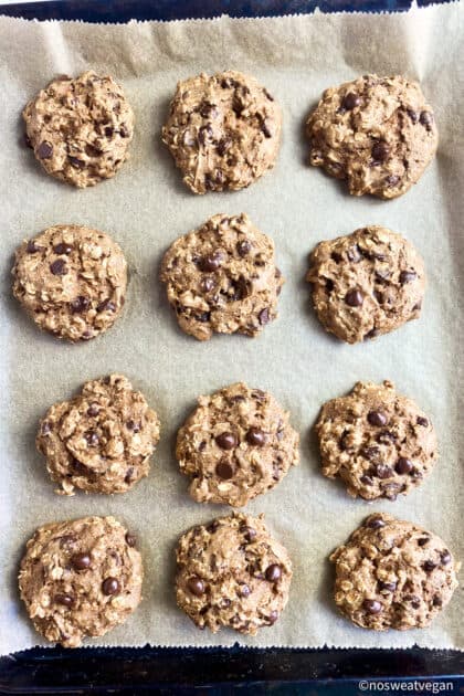 Vegan oatmeal cookies just out of oven on baking sheet.