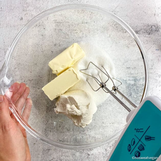 Vegan butter, cream cheese, and sugar in a bowl about to be mixed.