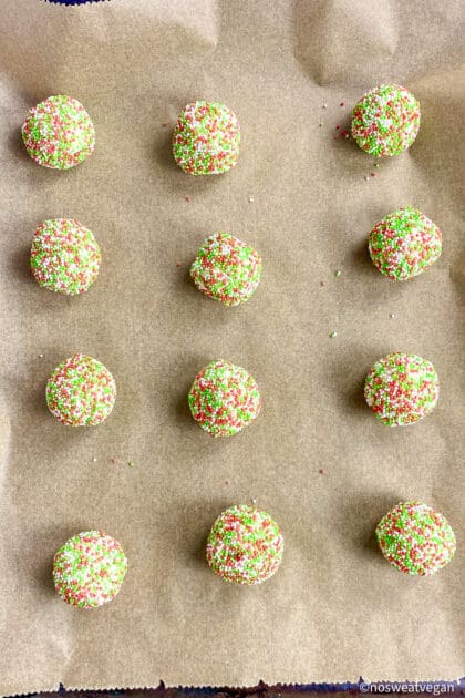 Unbaked vegan Christmas cookies on baking sheet.
