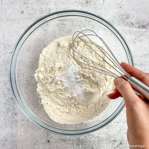 Hand whisking dry ingredients.