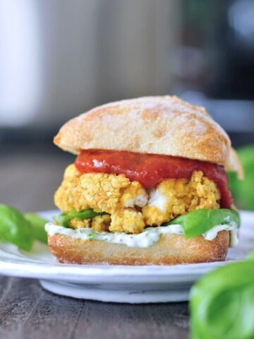 Mozzarella-stuffed vegan chickpea burger on a plate.