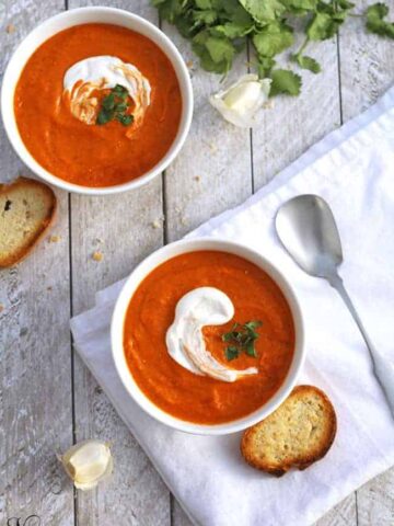 Two bowls of roasted tomato and chickpea soup.