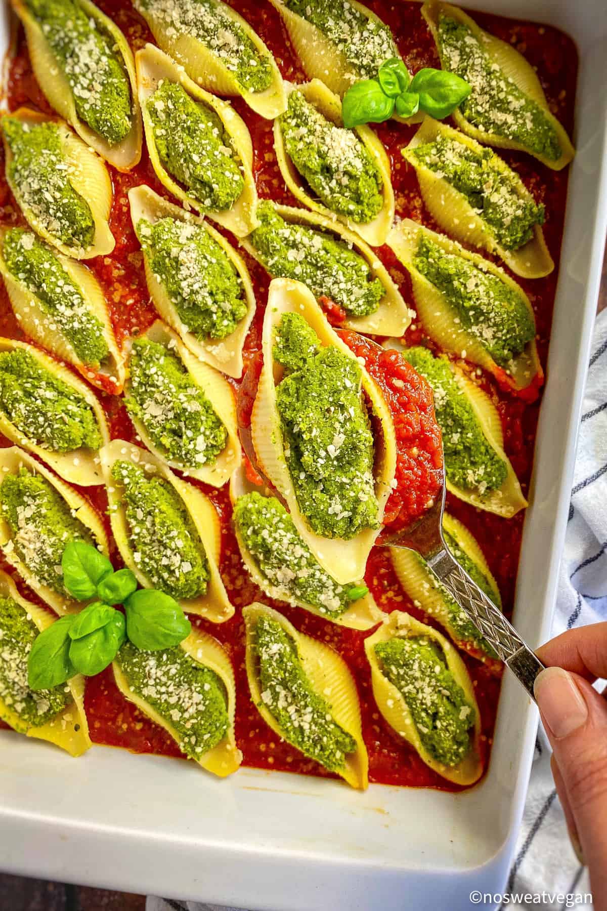 Stuffed vegan pasta shells in baking dish.