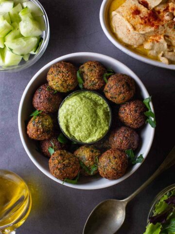 Vegan falafel on plate with dip.