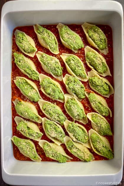 Vegan stuffed shells in dish before baking.