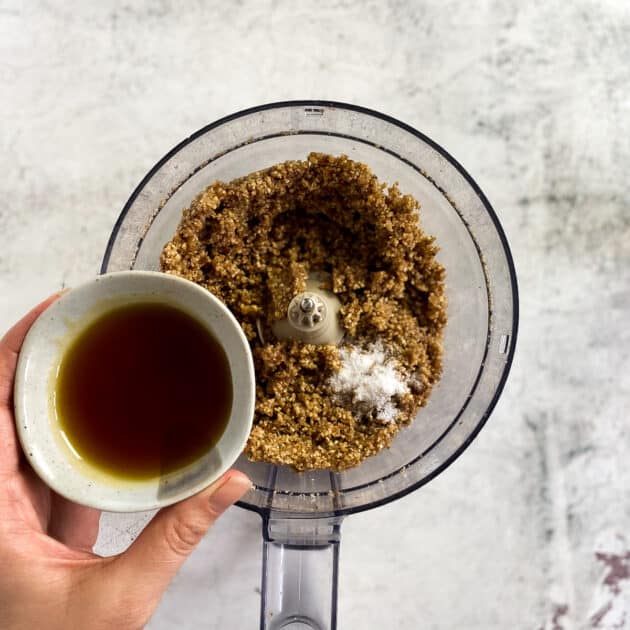 Add maple syrup to pecan and walnut mixture.