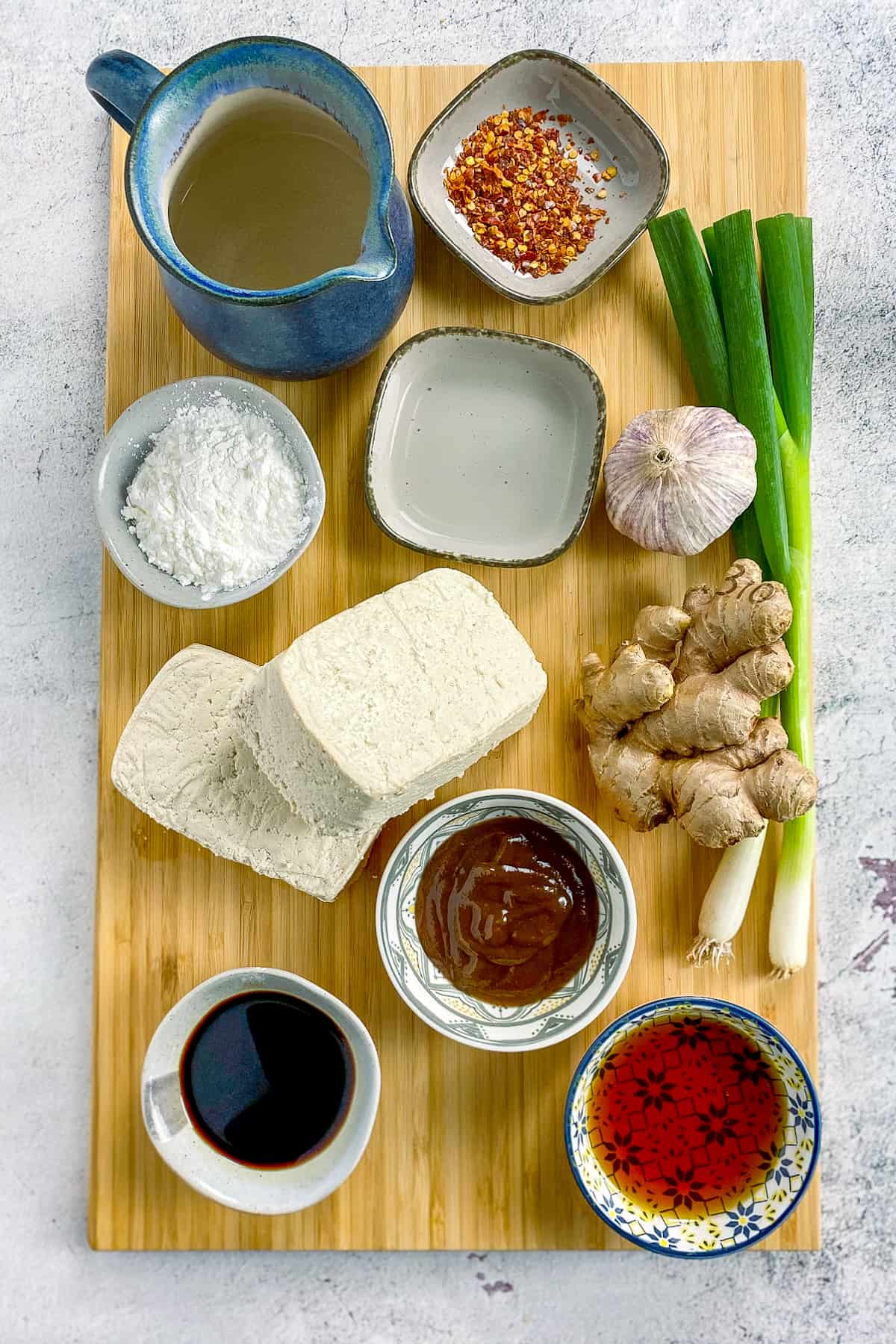 Ingredients for general tso tofu on a cutting board.
