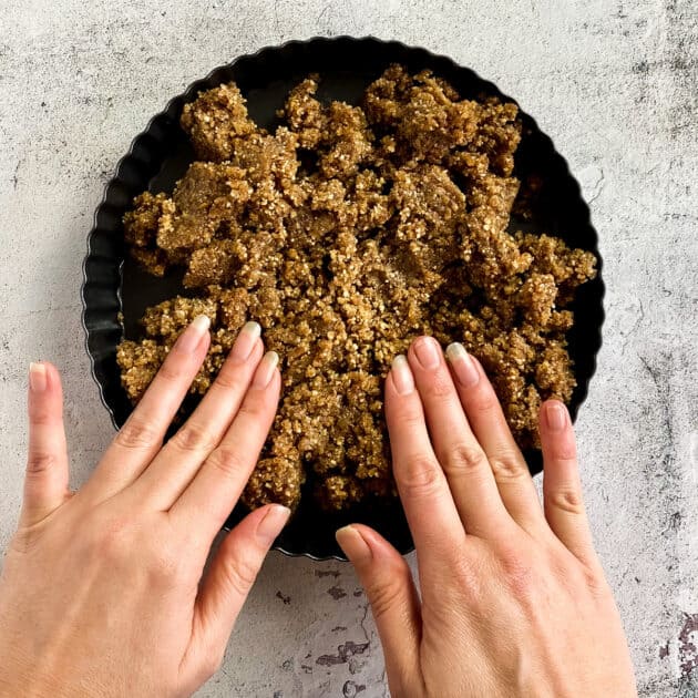 Press the crust into the tart pan.