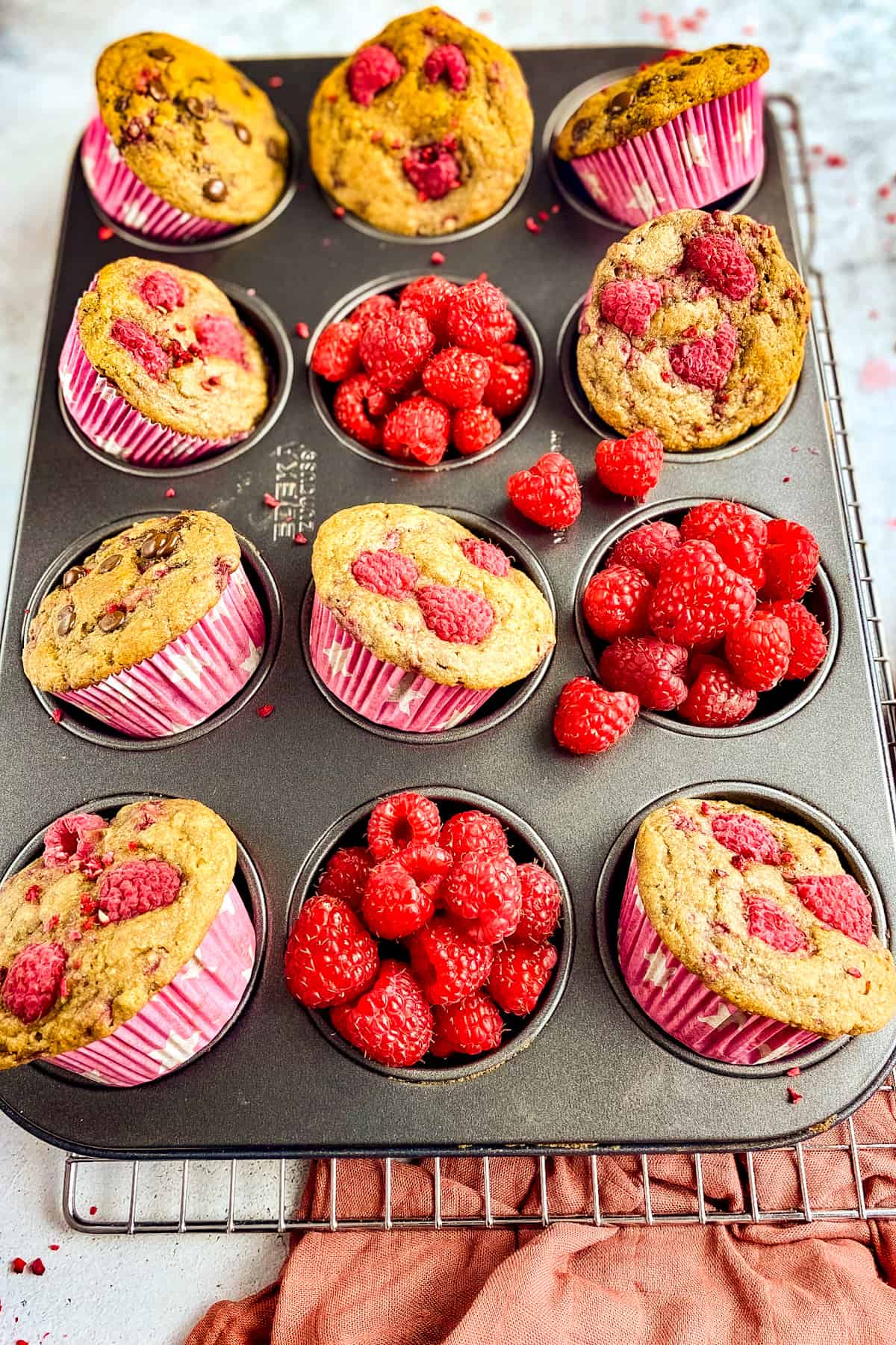 Raspberry vegan muffins in a tray.