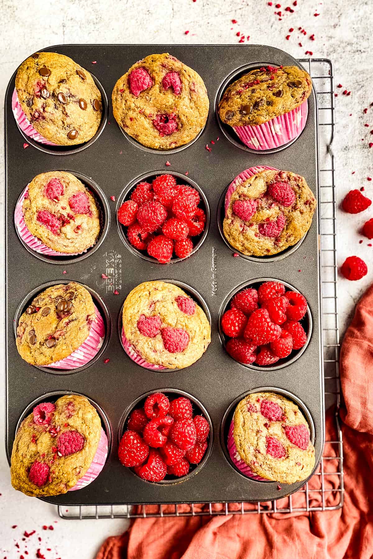 Vegan raspberry muffins in a tray.