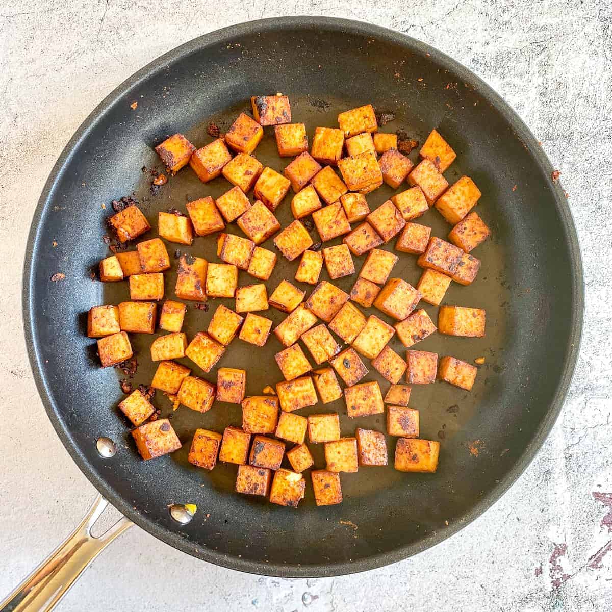 Cook marinated tofu in skillet.