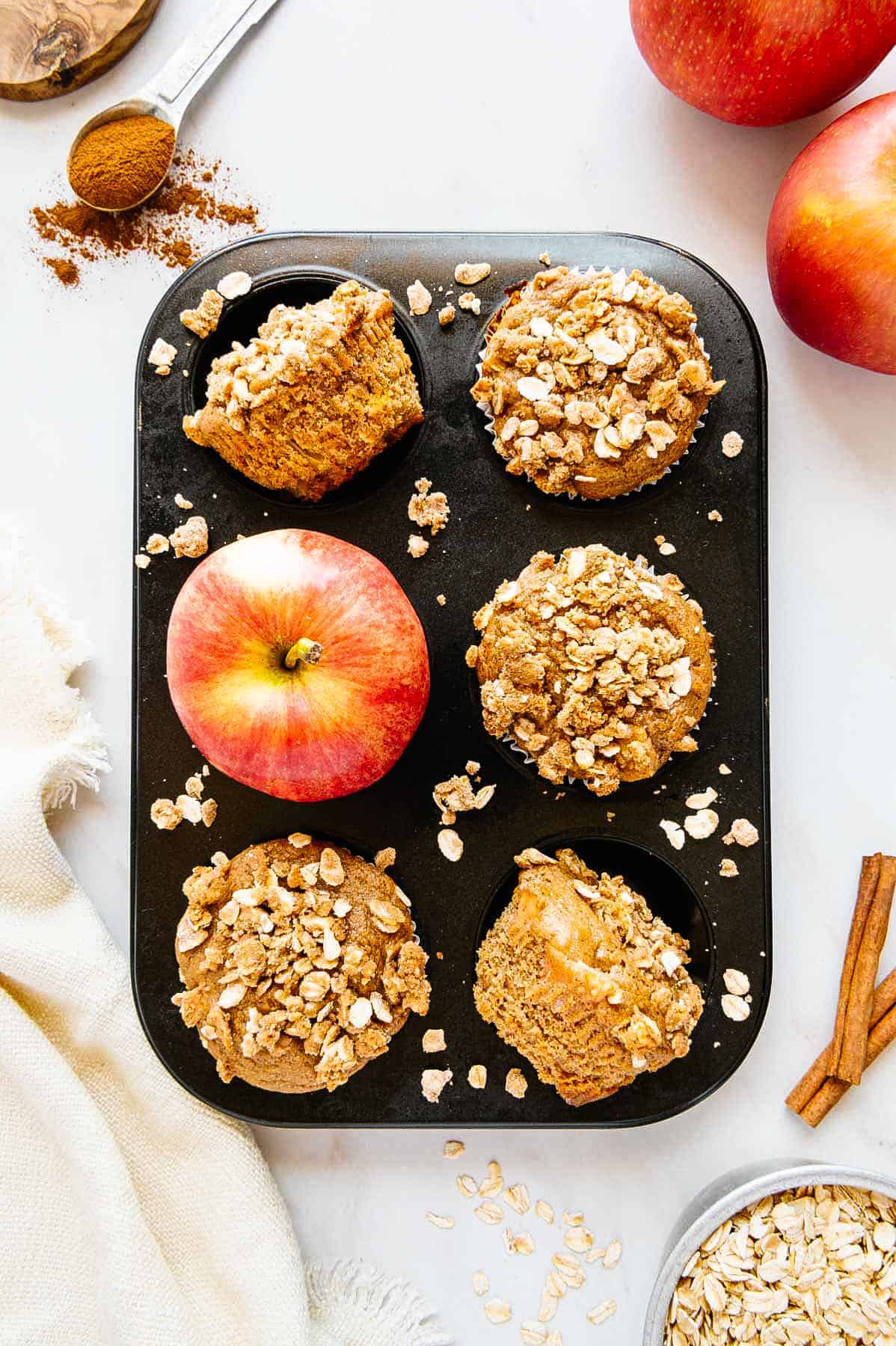 Vegan muffins in tray with apple.