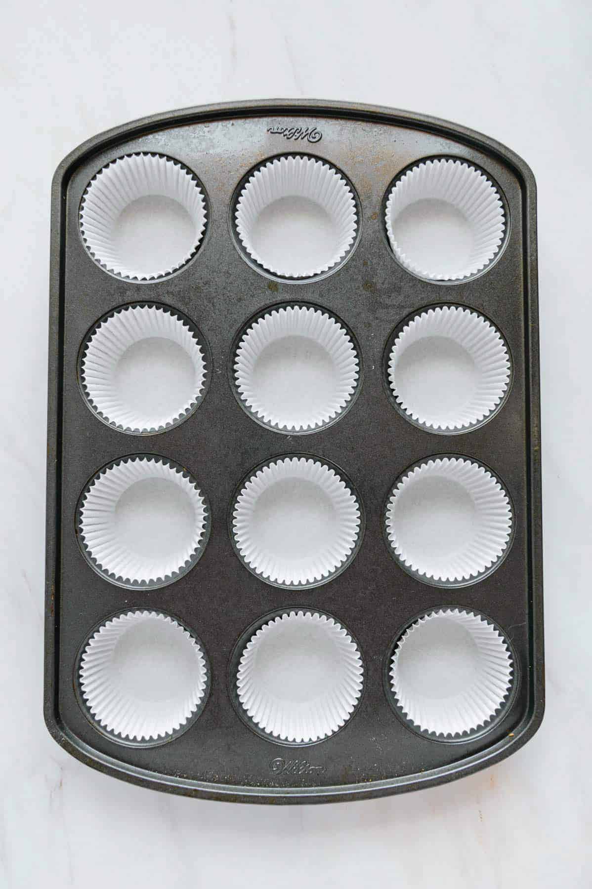 Muffin tray with paper liners.