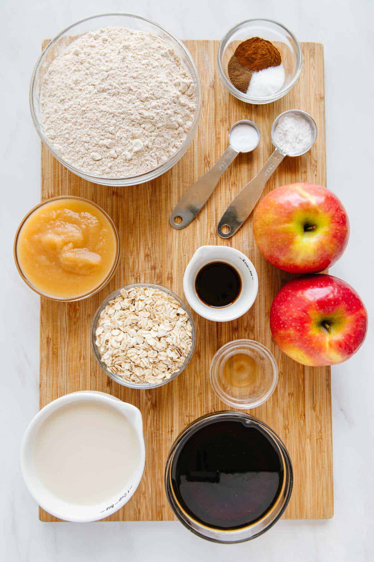 Vegan apple muffins ingredients on a cutting board.