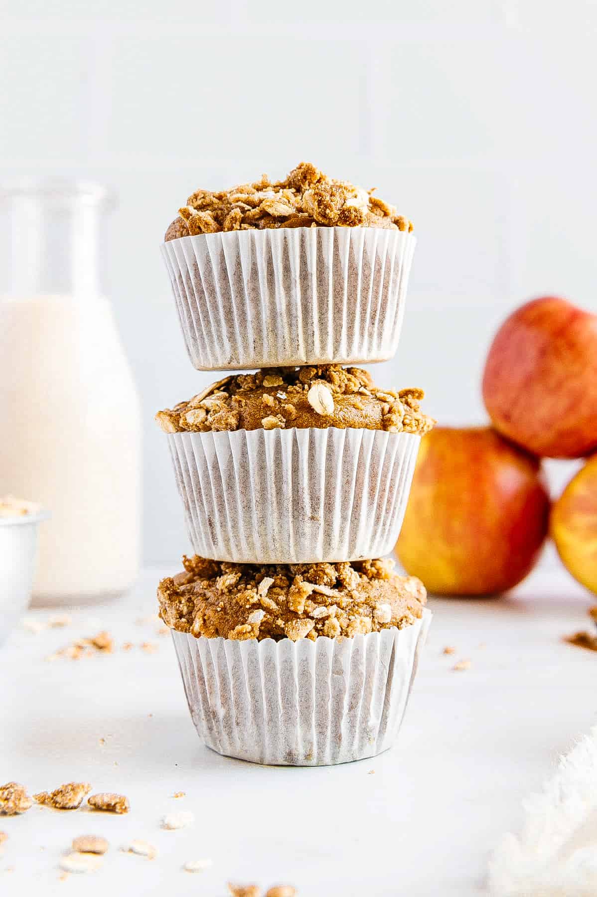 Three vegan apple muffins in a stack.