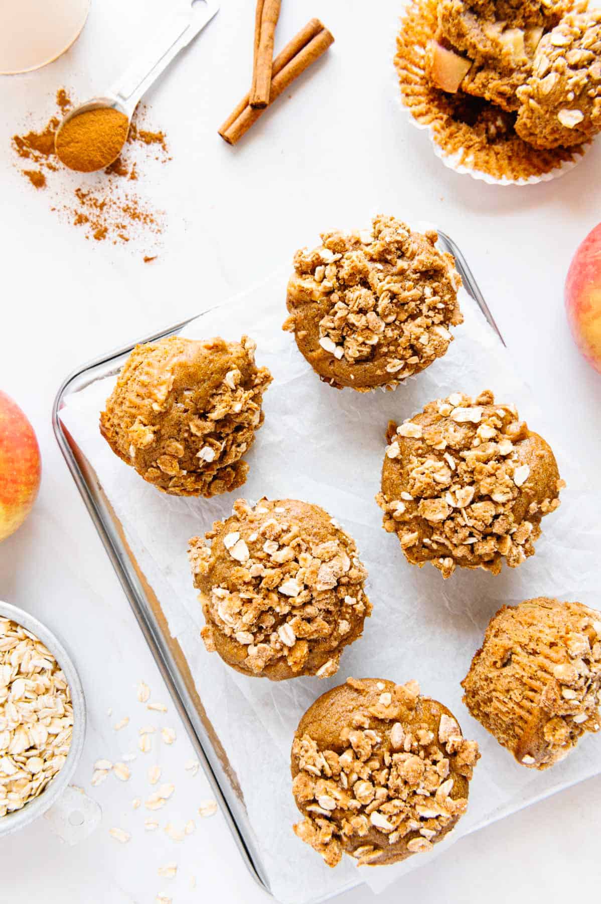 Apple muffins on a lined tray.