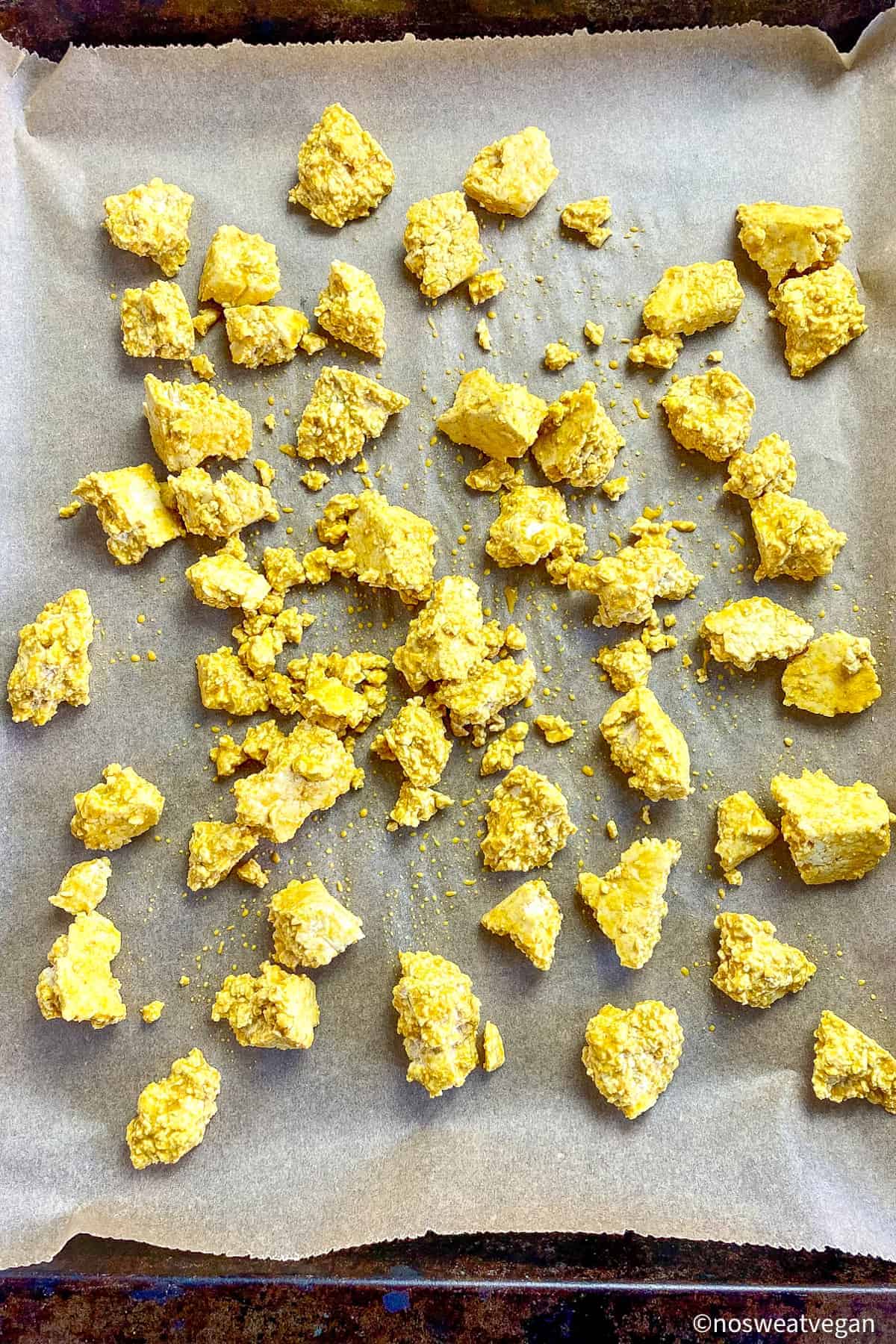 Curried tofu on a baking sheet.