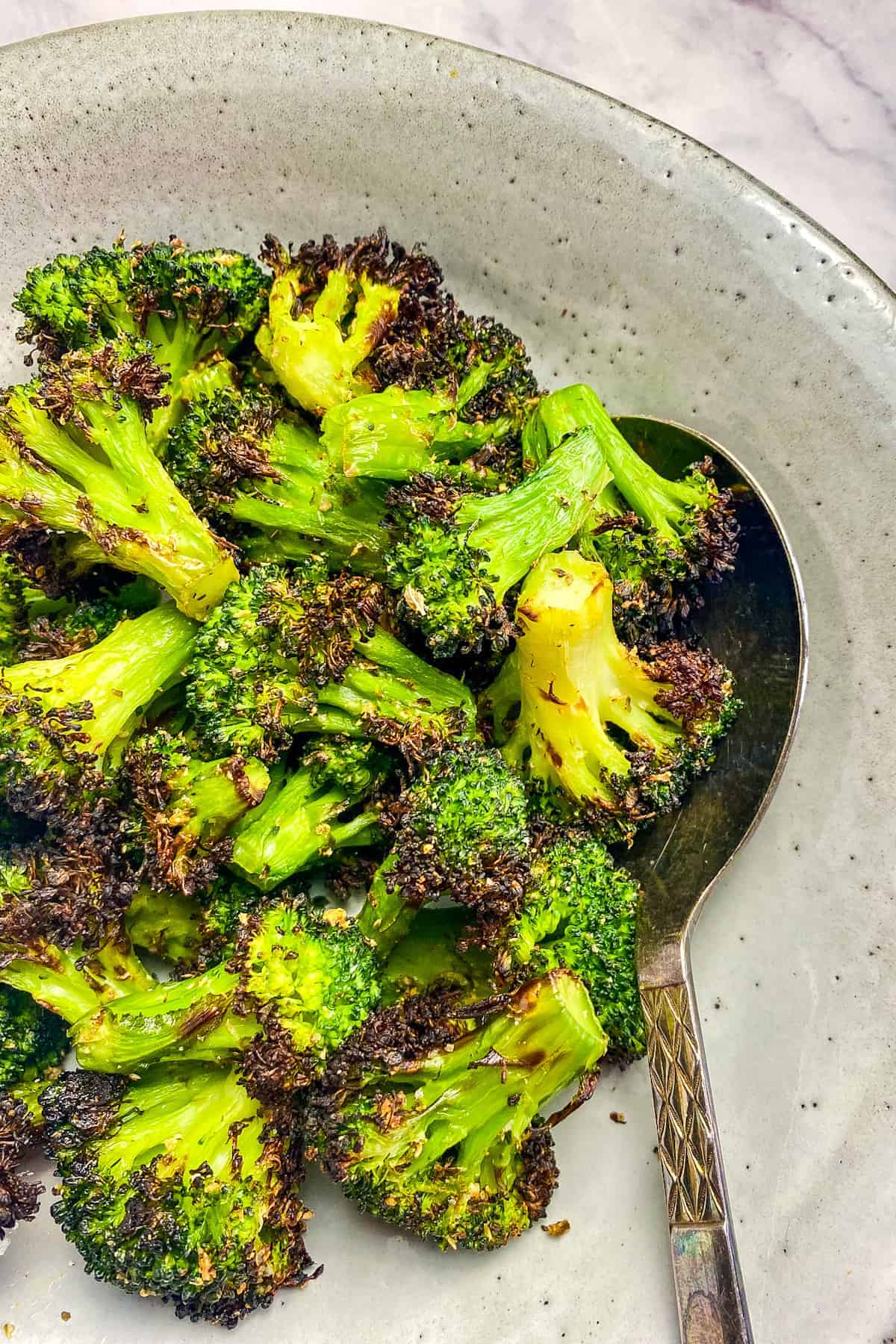 Air fryer frozen broccoli in a bowl.