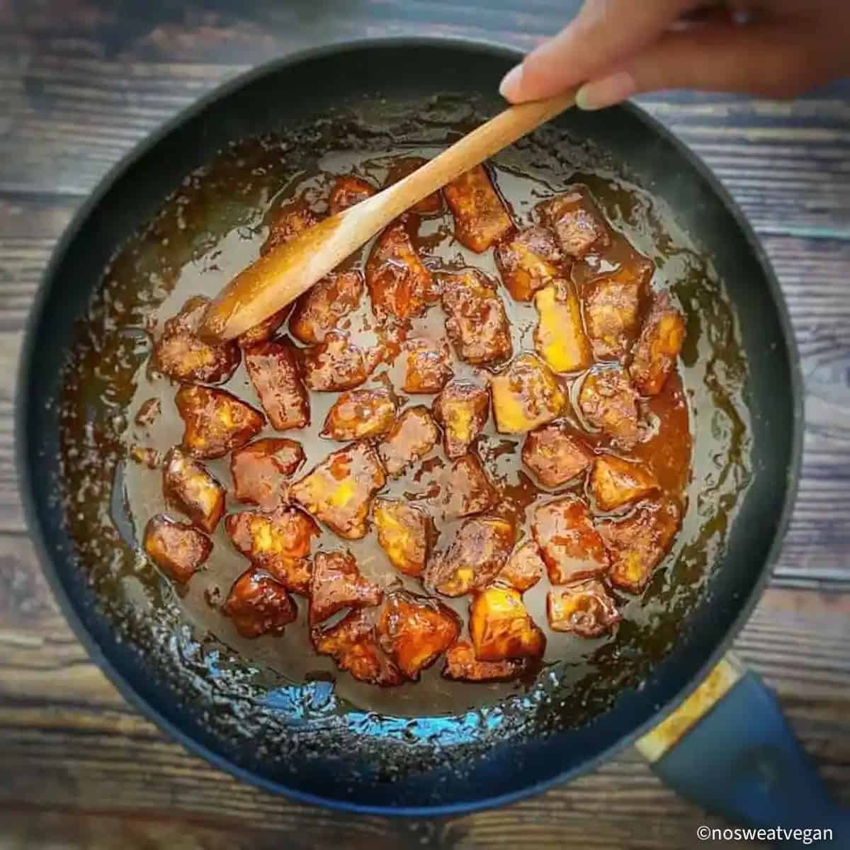 Skillet with vegan orange chicken.