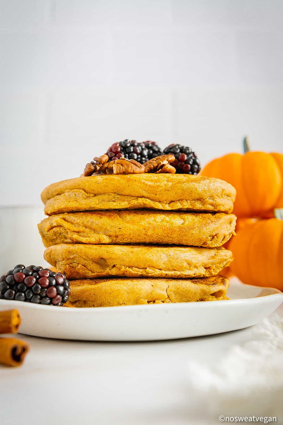Vegan pumpkin pancakes stacked on a plate.