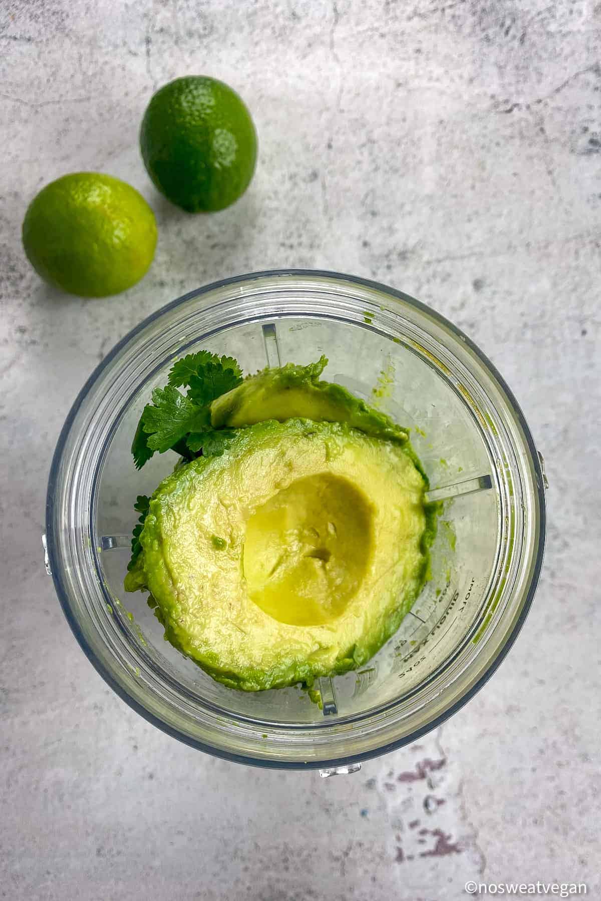 Avocado crema ingredients in a blender.