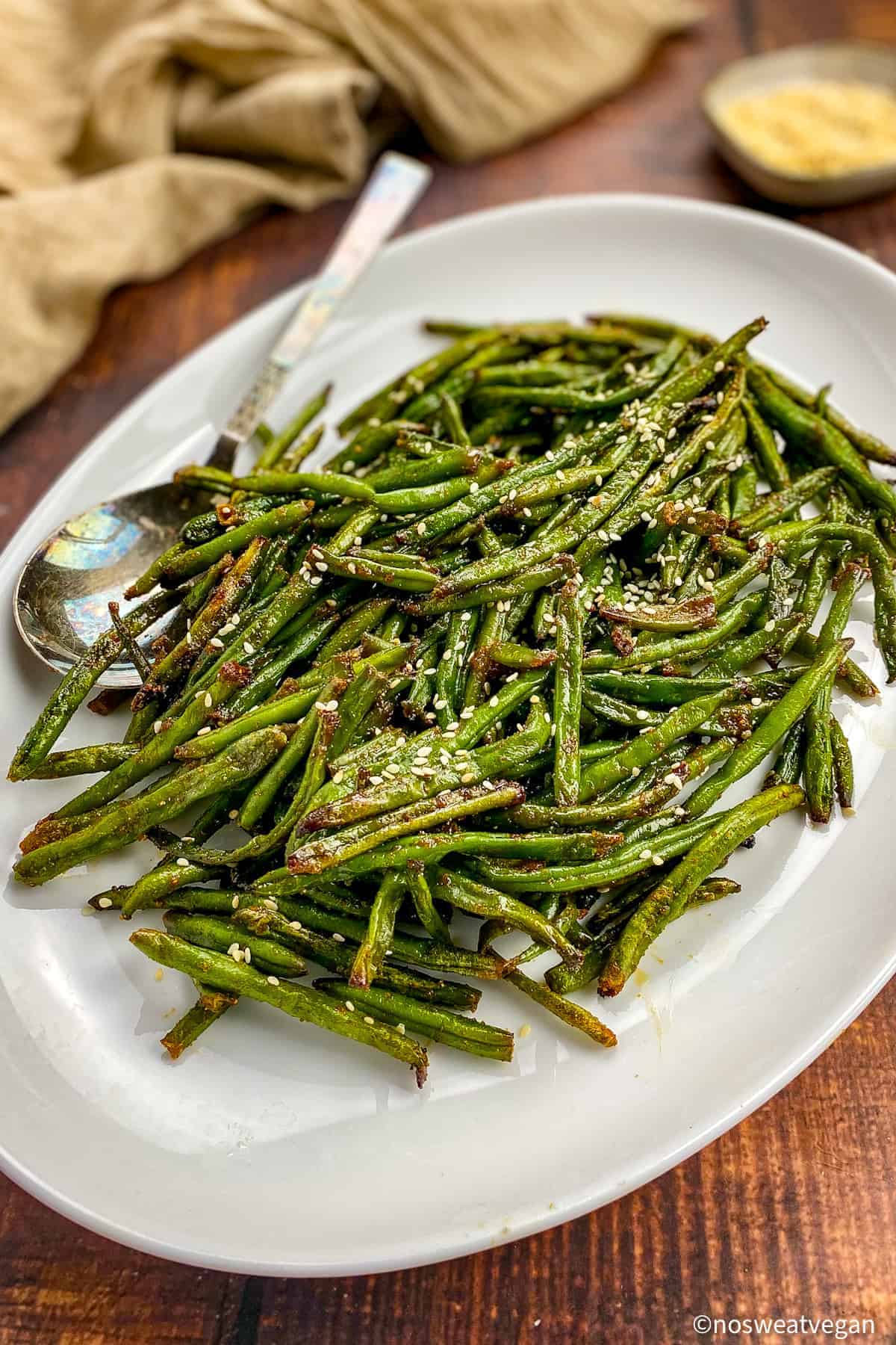Air fried frozen green beans on a plate.