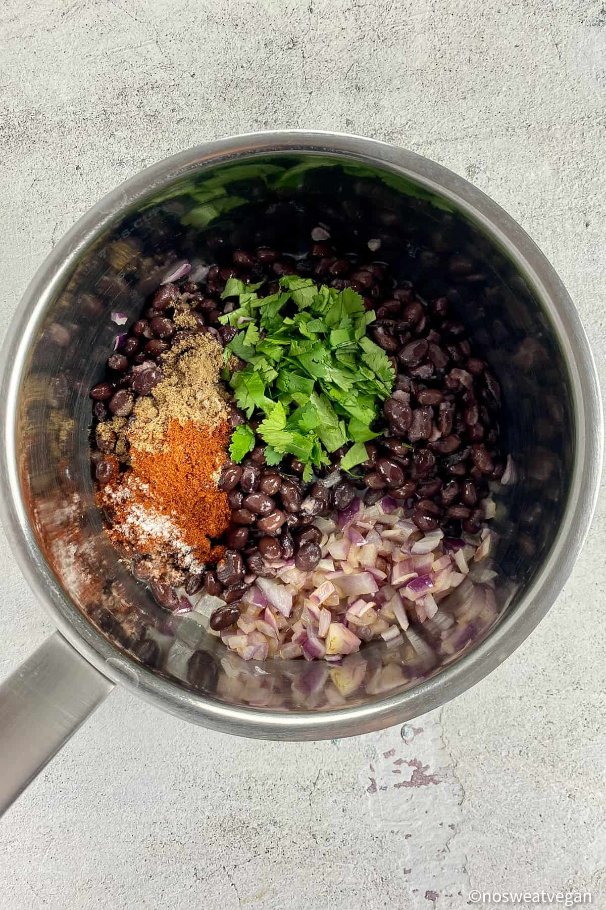Ingredients for black bean filling in a pot.