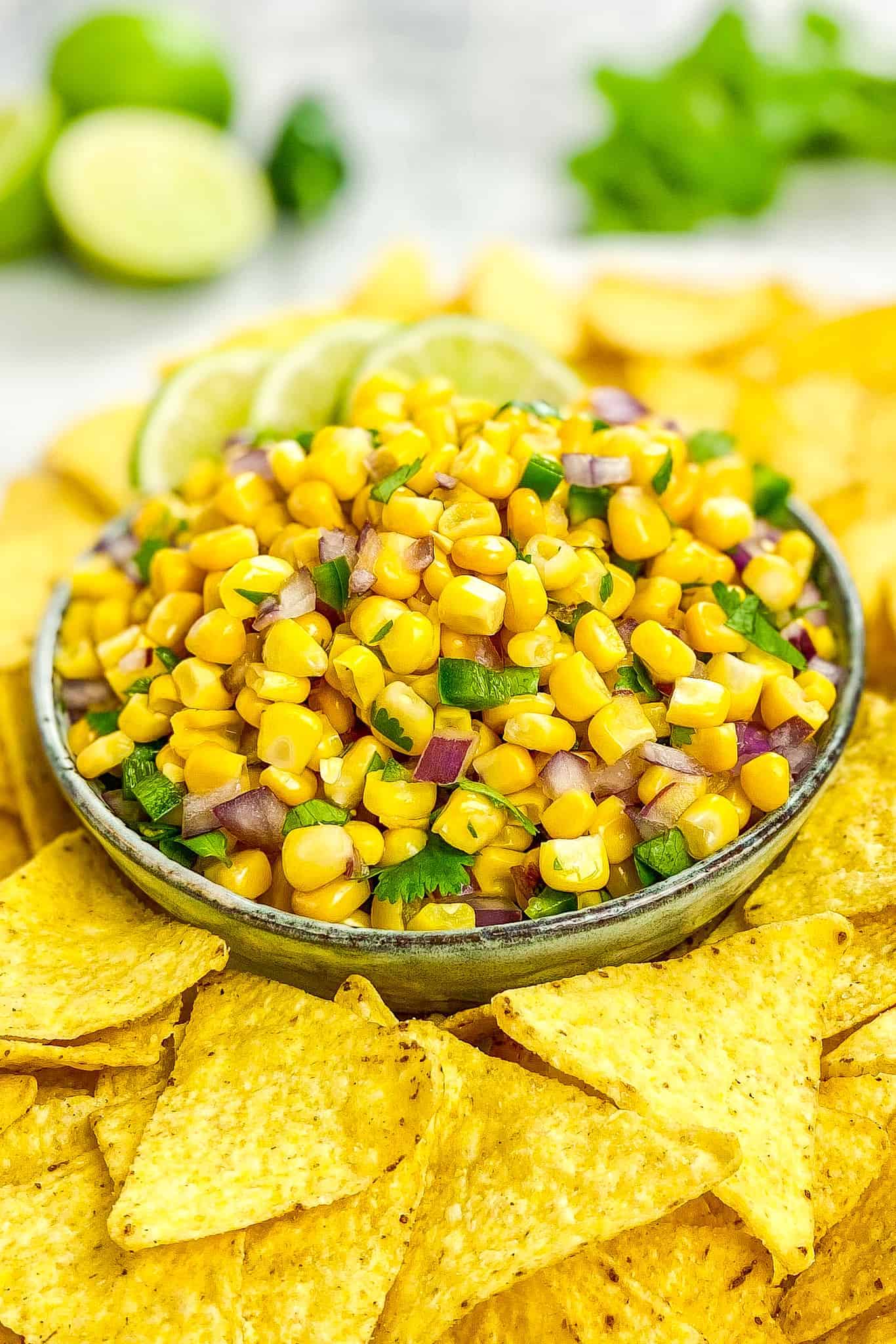 Chipotle corn salsa in a bowl surrounded by chips.