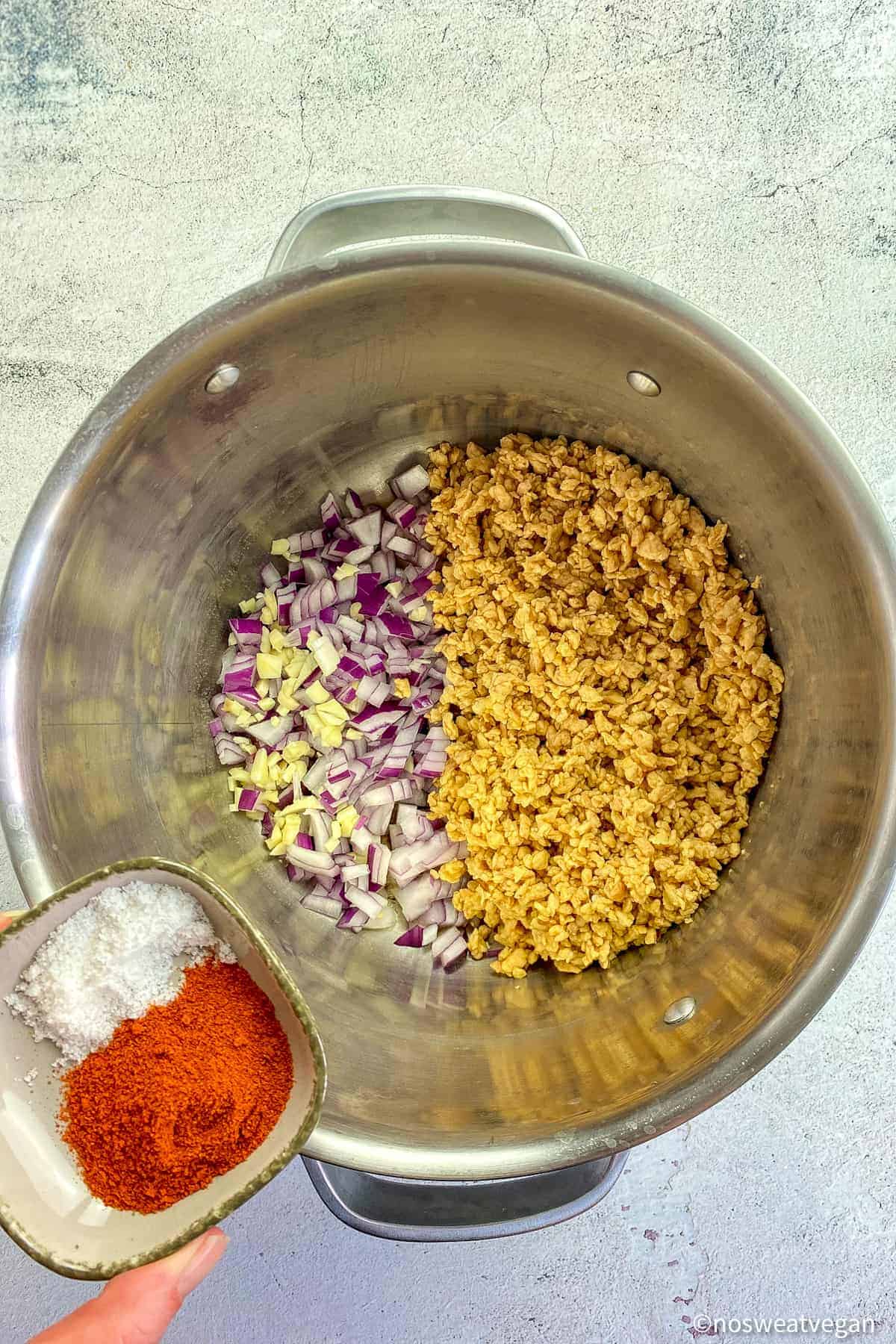 Pot with vegan chili meat, onions, garlic, and spices.