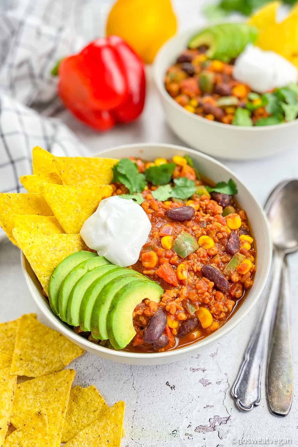 Chili sin carne in a bowl with garnishes.