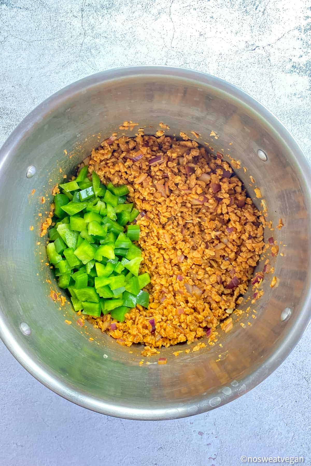 TVP meat and green peppers in a pot.