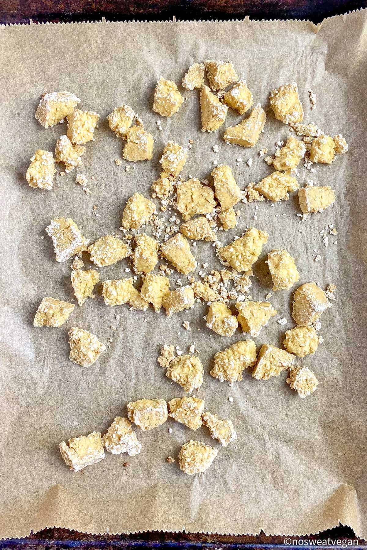 Baking sheet with cooked tofu pieces.