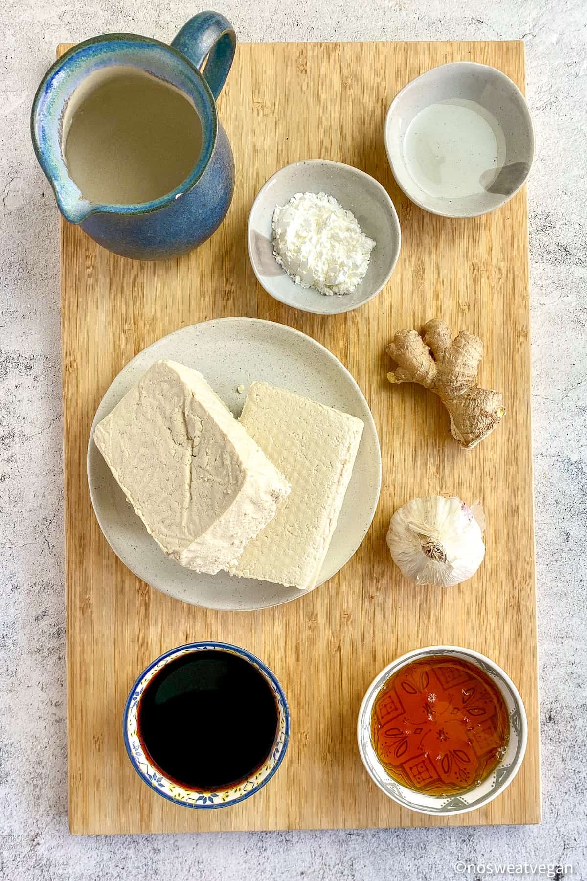 Ingredients to make teriyaki tofu on a cutting board.
