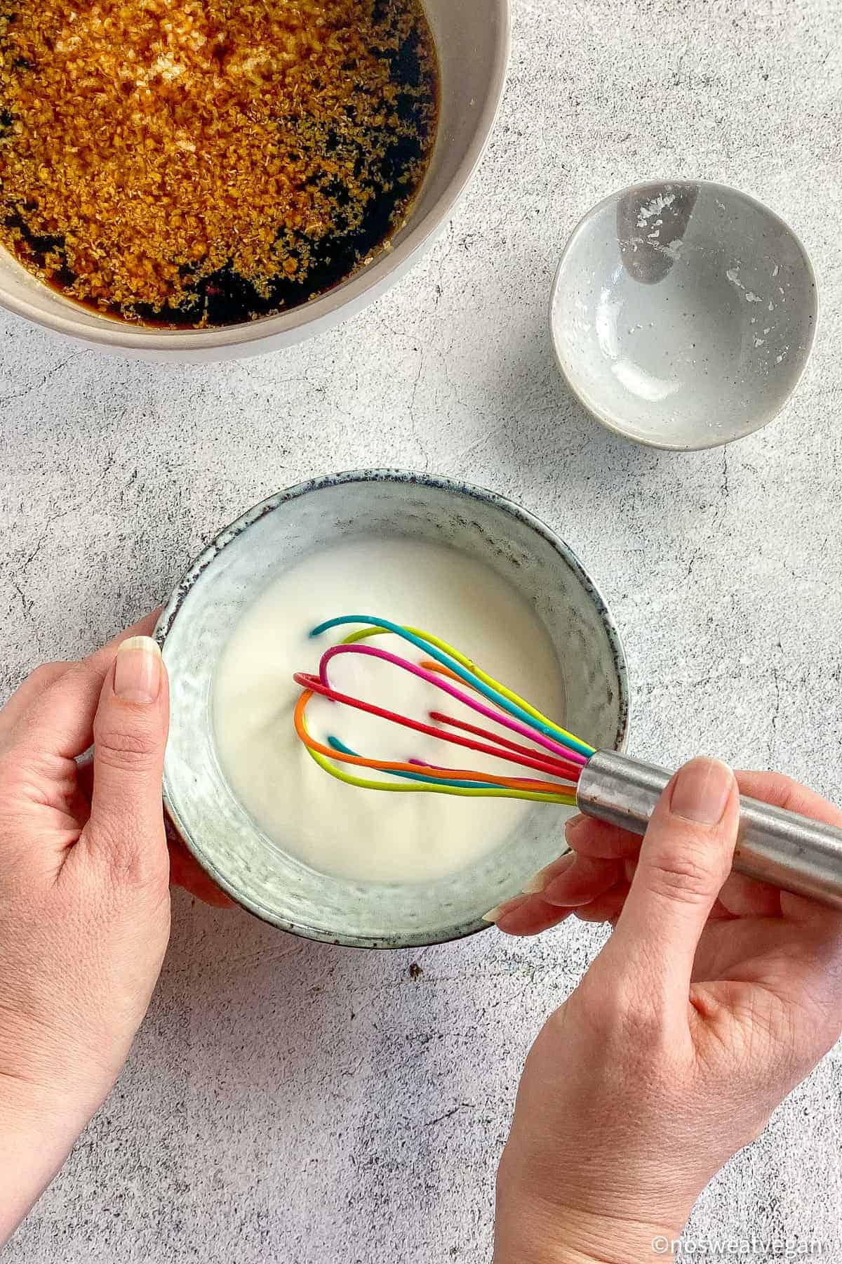 Hand whisking the cornstarch and water.