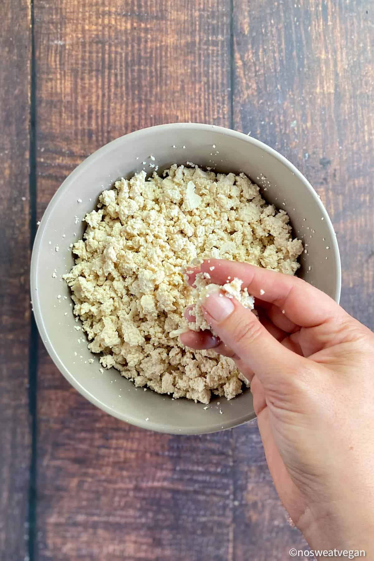 Hand crumbling tofu for taco meat.