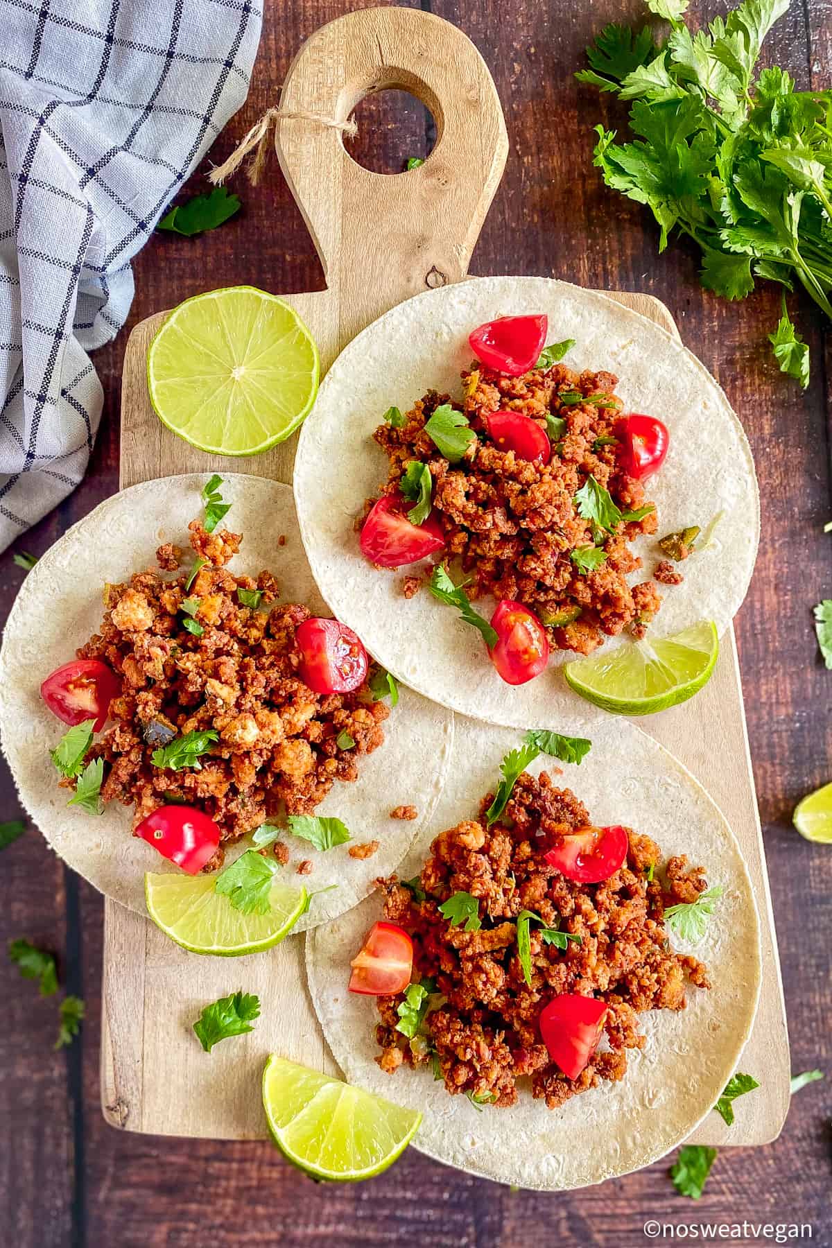 Crumbled tofu tacos on a board.
