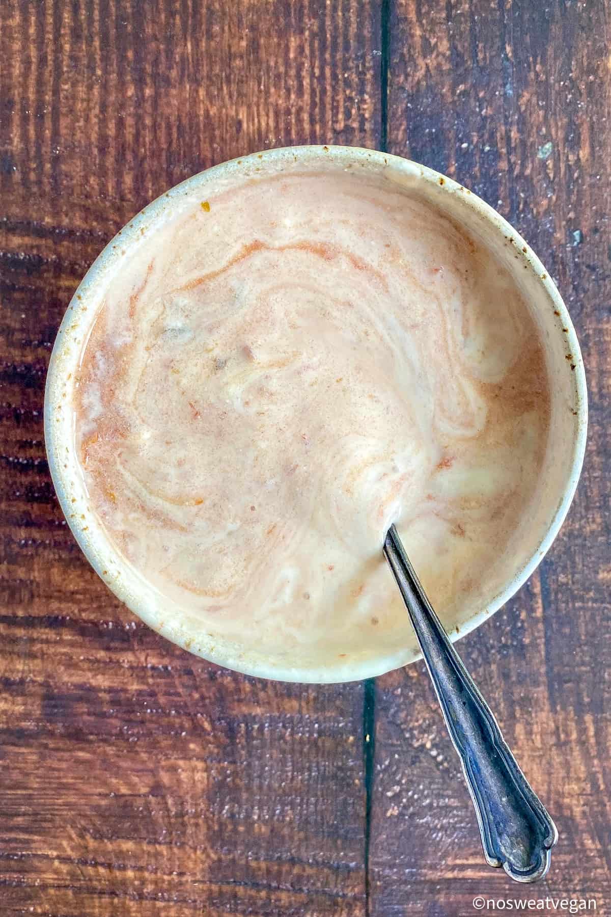 Vegan taco salad dressing mixed.