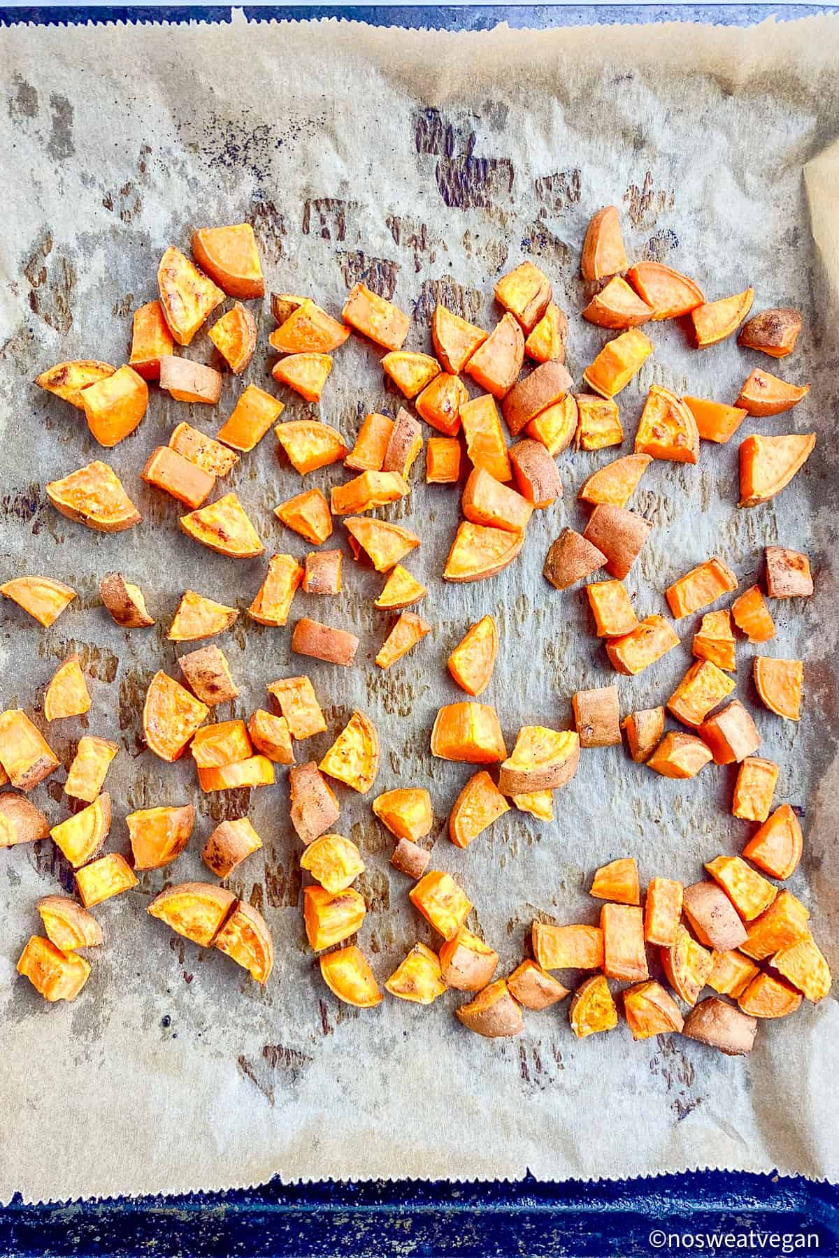Roasted sweet potatoes on a baking sheet.