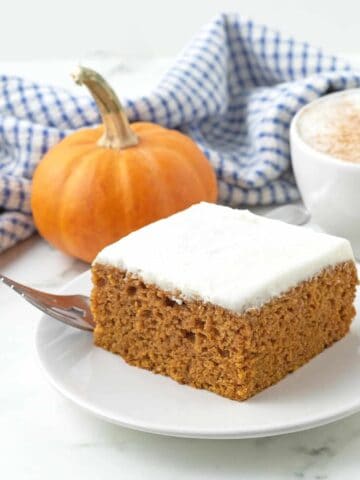 Vegan pumpkin bars next to a pumpkin.