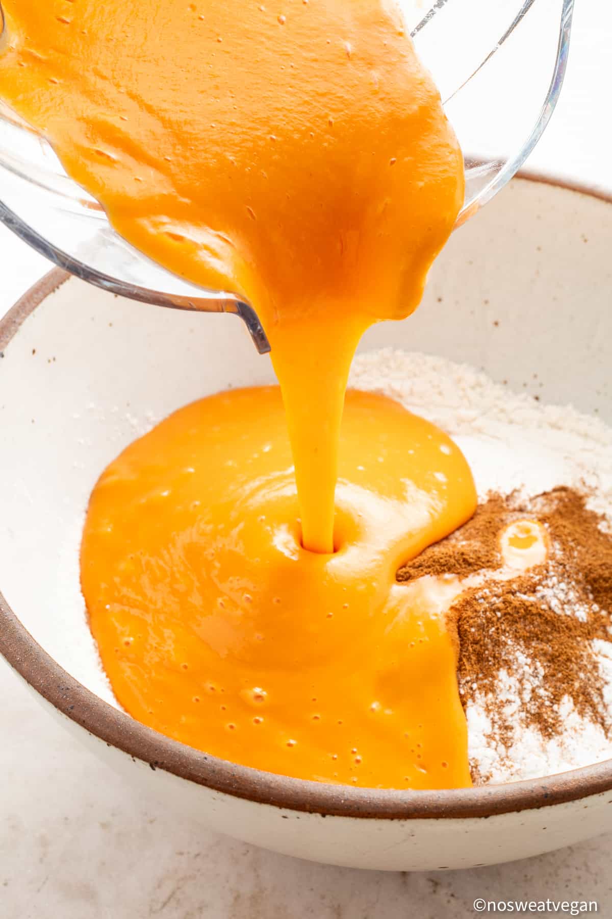 Pouring sweet potato mix into dry ingredients.